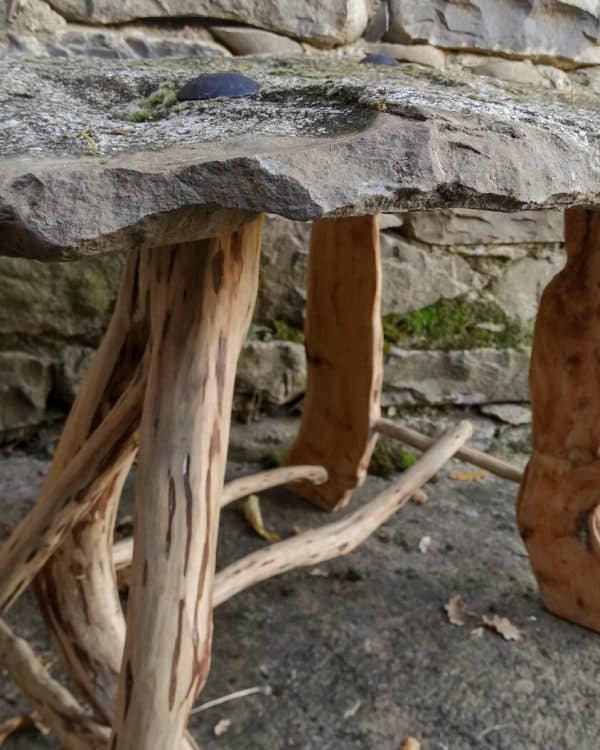 Mesa de centro de piedra natural y patas con madera de enebro